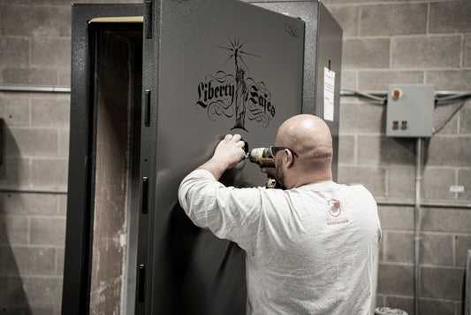 Technician installing a lock on a Liberty Safe gun safe